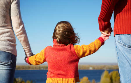 mother,father and daughter on nature background, focus on centerの写真素材