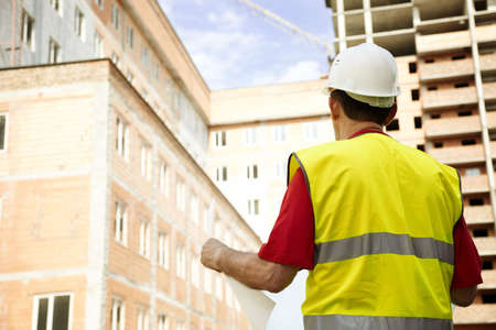 Building Inspector Reviewing Blueprints の写真素材