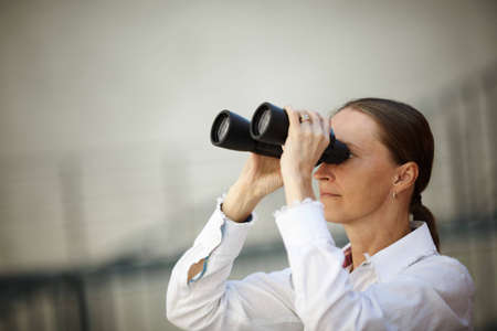 woman looking through binoculars ,business or lifestile conceptの写真素材
