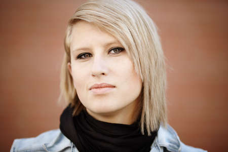 blond young woman ,urban portrait, natural lightの写真素材
