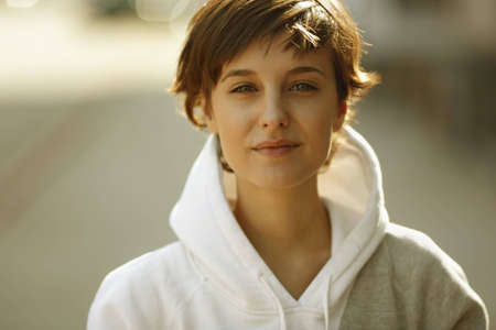 real beautiful girl on the street background, natural lightの写真素材