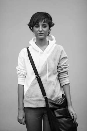 sad teen with black bag, soft natural light ,selective focus on faceの写真素材