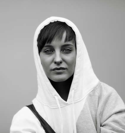 sadness in her eyes, young woman with white hood ,special black and white toned f/xの写真素材
