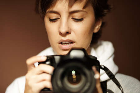 young woman with black slr camera, natural lightの写真素材