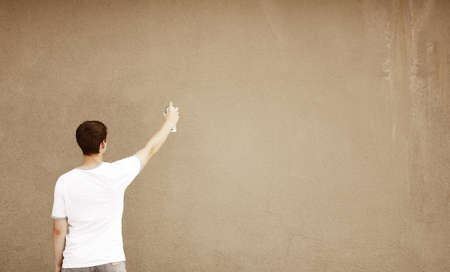 young teen with paint spray and empty ares for your text, selective focus on headの写真素材