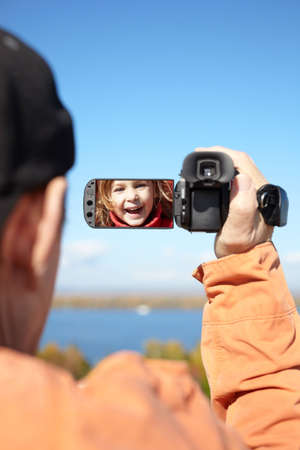 man recording with  camera, focus on the screenの写真素材