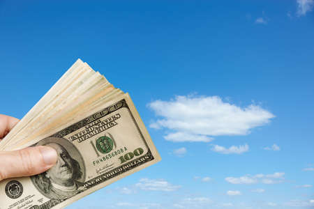 finance concept with cash and blue skyの写真素材