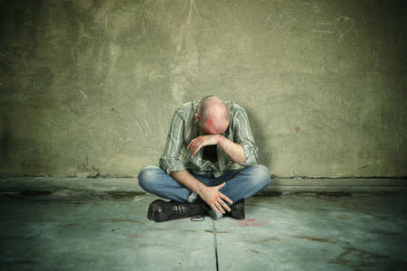 tired man after street fight の写真素材