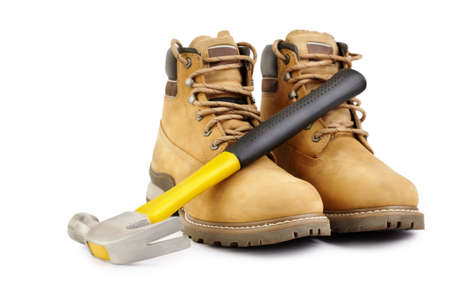 Working boots and hammer isolated on white background, selective focusの写真素材