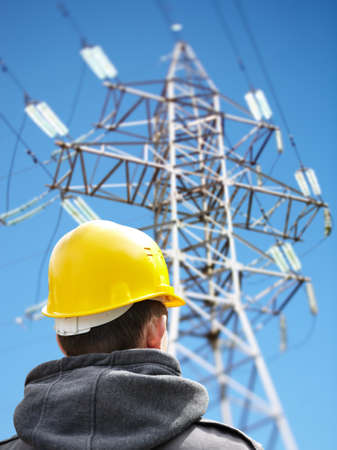 utility worker against power lines
