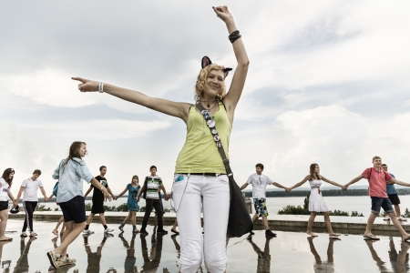 Samara,Russia-July 6, 2012: Happy young russian woman choose other teens for the kissのeditorial素材