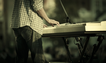young man playing electronic keyboard, selective focusの写真素材