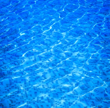 pure and clear blue water in a swimming pool, summer backgroundの写真素材