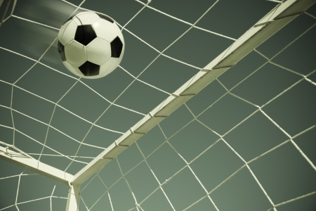 Soccer ball going into goal net ,selective focusの写真素材