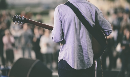 play on guitar, selective focus on the manの写真素材
