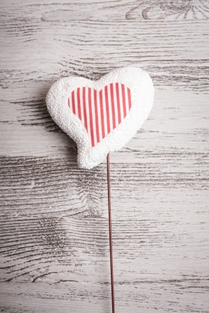 white heart on stick ,wooden backgroundの写真素材