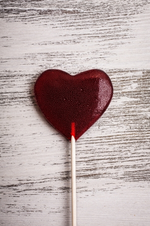 Red candy heart on the wooden backgroundの写真素材