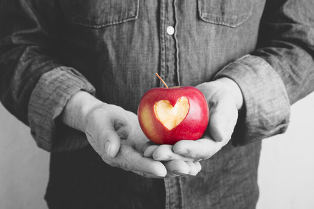 red apple with hands of manの写真素材