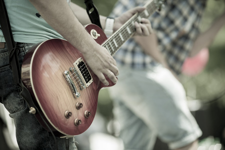 play on guitar, selective focus on part of stringsの写真素材