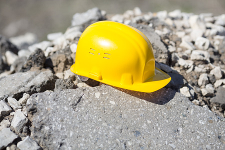 yellow hardhat on construction site, natural lightの写真素材