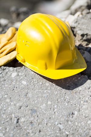yellow hardhat and gloves, natural light, selective focusの写真素材