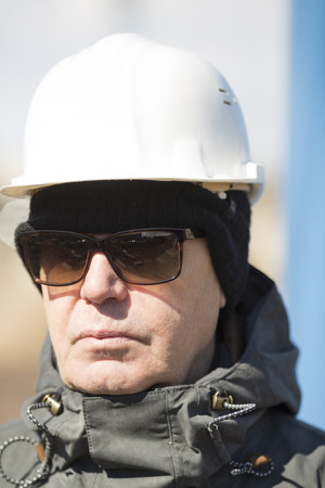 man with white hardhat and sunglassesの写真素材