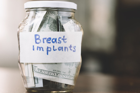jar with money in closeup for breast implantsの写真素材