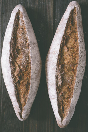 A homemade breads on a rustic wooden dark tableの写真素材