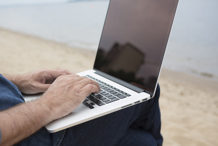 man with laptop on the beachの写真素材