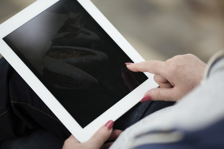 real woman with tablet pc on the streetの写真素材