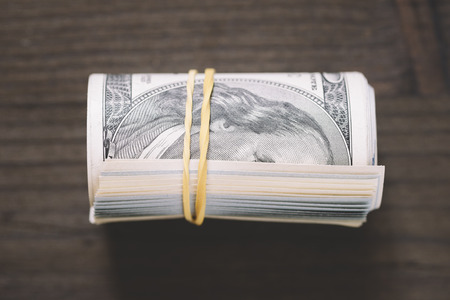 Roll of US one hundred dollar bills, selective focus の写真素材