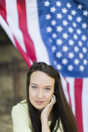 portrait of woman with the american flagの写真素材