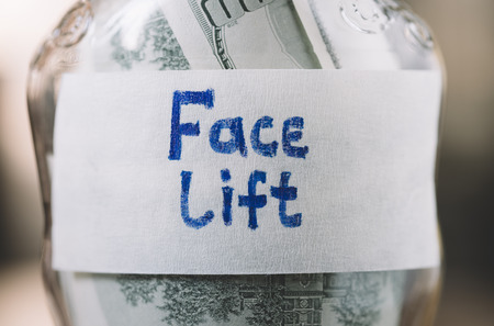 jar with money in closeup for face liftの写真素材