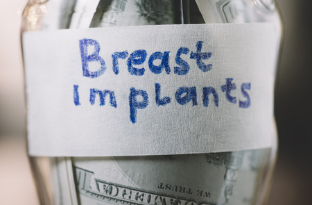 jar with money in closeup for breast implantsの写真素材