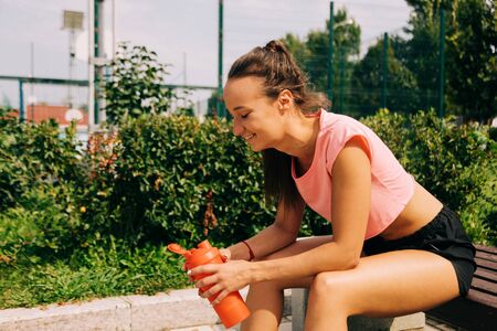 sportive woman in sportswear working out on streetの写真素材