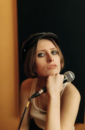 young musician with mic  in recording studioの写真素材