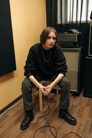 Singer performing in a recording studioの写真素材