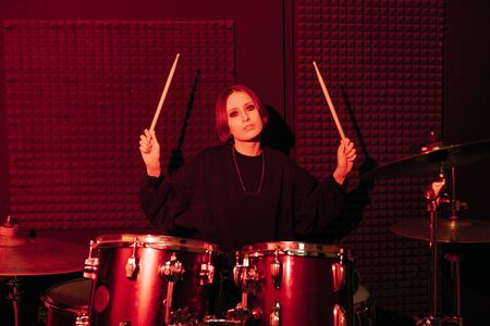 Young woman playing drums, selective focus