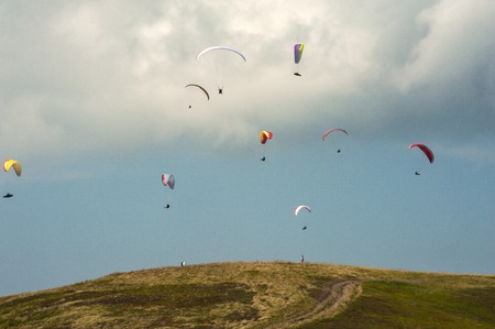 Competitions paragliders on the ridge Borzhava in the Carpathians in Ukraine. A large group of paragliders.の写真素材