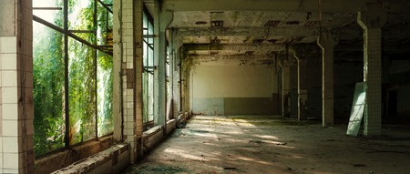 Industrial interior at the old electronic devices factory with big windows and empty floor. Interior...