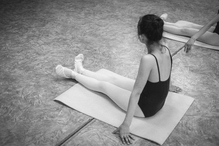 Ballerina dancing in the dance hall. Close-up of a ballerina in the dance hall. Black and white photography.の写真素材