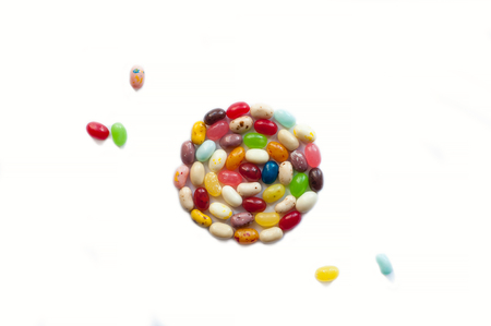 Brightly colored candy beans. Colorful jelly bean background. Jelly beans isolated on white background.の写真素材