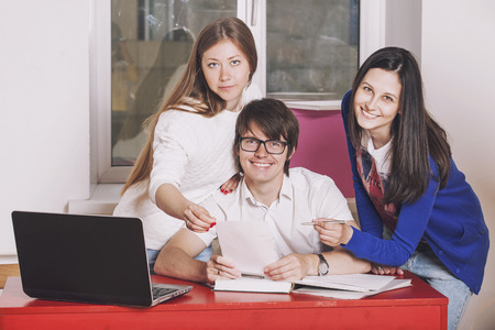 People friends working at home at the table with laptopの写真素材