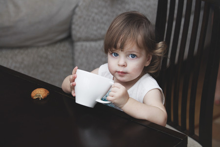 The girl child with a mug of homeの写真素材