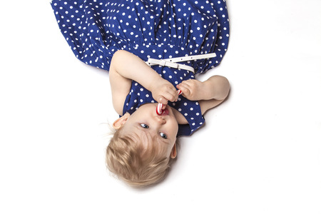 Little baby girl with sweets in the Studioの写真素材