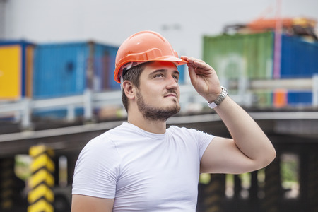 Man the Builder working foreman in the helmet to ensure safety on the construction site. Worker, engineer, foreman, architect.の写真素材