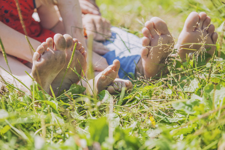 Family, mom, dad and child on the nature of the toe, heel. The rest, values, children, love, beauty, summer, Sunnyの写真素材