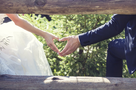 Man and woman couple holding hands on a romantic date or a weddingの写真素材