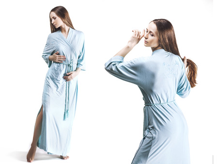 Model beautiful women in dressing gown in full length isolated on white backgroundの写真素材