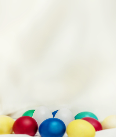 Two white eggs among the colored eggs look like cute Bunny ears, holiday decoration, happy Easter!の写真素材